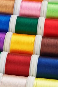 Background from spools with multi-colored sewing threads, photo stacking Stock Photos