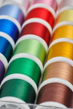 Background from spools with multicolored sewing threads Stock Photos