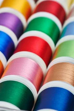 Background from spools with multicolored sewing threads 스톡 사진