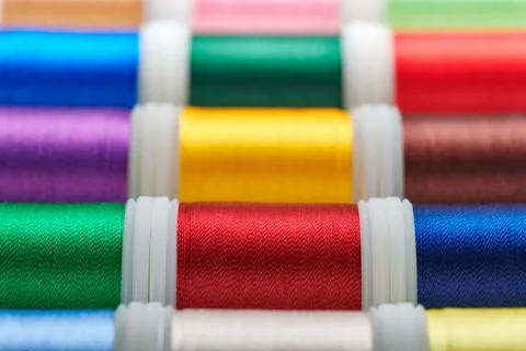 Background from spools with multicolored sewing threads Stock Photos