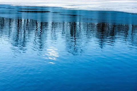 Background of spring water with a thawed patch Stock Photos