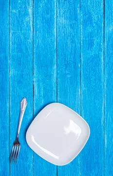 Background with squared empty white ceramic plate, antique silver cutlery on Stock Photos