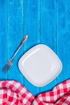 Background with squared empty white ceramic plate, antique silver cutlery on Stock Photos