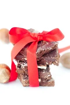 Background of stack of chocolate with red ribbon and nuts Foto stock