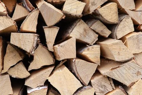 Background from a stack of firewood for heating a house, stacked in the backy Stock Photos
