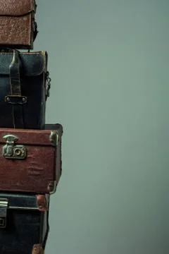 Background stack of old shabby suitcases form a tower Stock Photos