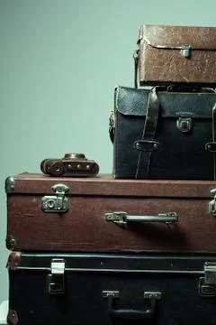 Background stack of old shabby suitcases and camera Stock Photos