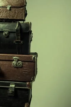 Background stack of old shabby suitcases form a tower Stock Photos