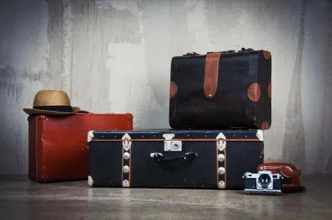 Background stack of old shabby suitcases and the camera. 스톡 사진
