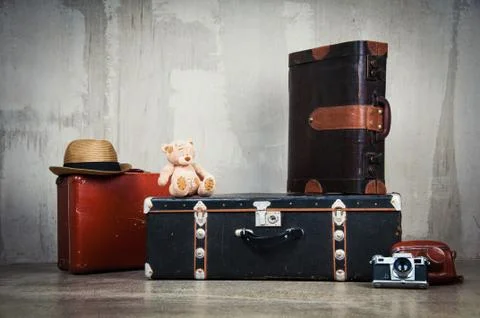 Background stack of old shabby suitcases and the camera. Stock Photos