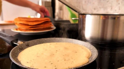 Background of a stack of pancakes, women's hands and pans Stock Footage 118664980