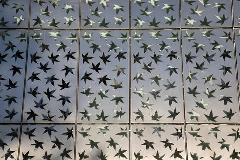 Background star-shaped perforated sheet metal steel lattice diagonal metal .. Stock Photos