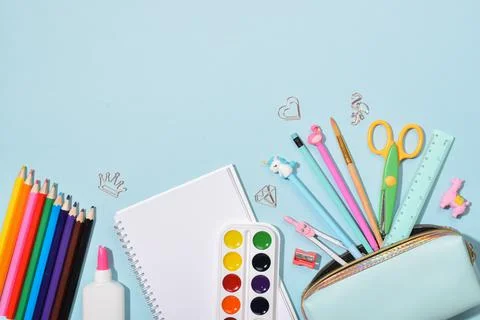 Background with stationery at the bottom on blue. Back to school. Stock Photos