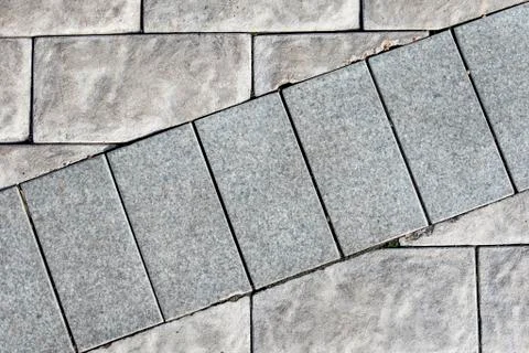 The background of a stone brick wall of gray color, where a number of bricks  Stock Photos