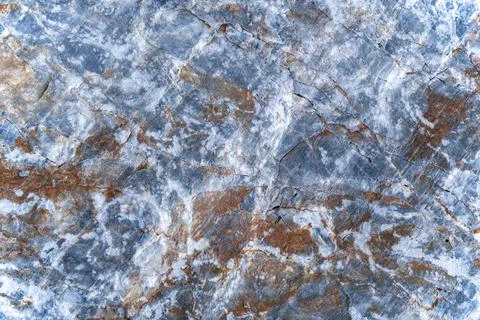 Background of stone surface containing gray, brown, white colors. Stock Photos