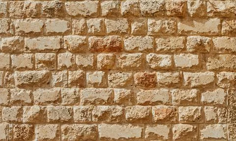 Background of the stone wall of the castle made of stones of different shapes Stock Photos