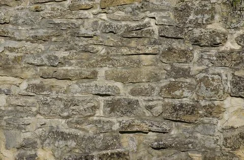 Background stone wall lined with natural stone, The stone wall is lined with  库存照片