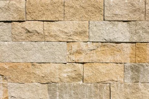 Background of stone wall made with blocks. Stock Photos