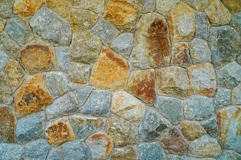 Background of stone wall texture. Closeup of stone wall texture. Stock Photos