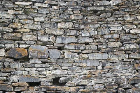 Background of stone wall texture .  Masonry stone wall rock construction pa.. Stock Photos