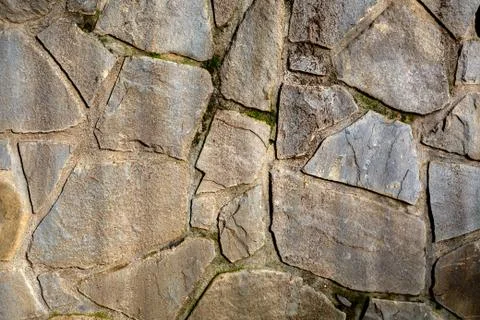 Background of stone wall texture. The surface of the stones is brown Stock Photos