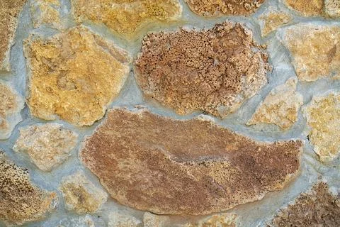 Background of stone wall texture. Yellow stone. Stock Photos