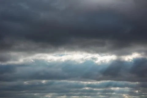 Background with stripes of thunderstorm clouds and sun rays Stock Photos