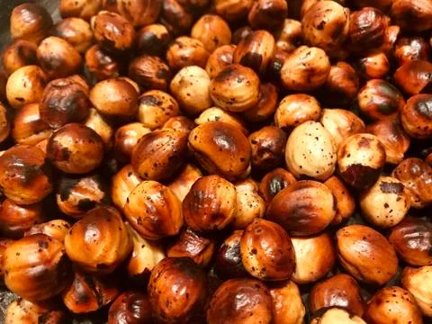 Background - strongly roasted nuts. Stock Photos