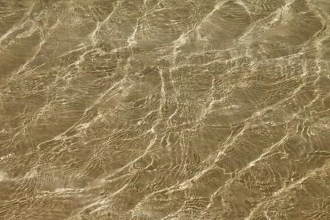A background of sun and shadows on sandy ocean floor Stock Photos