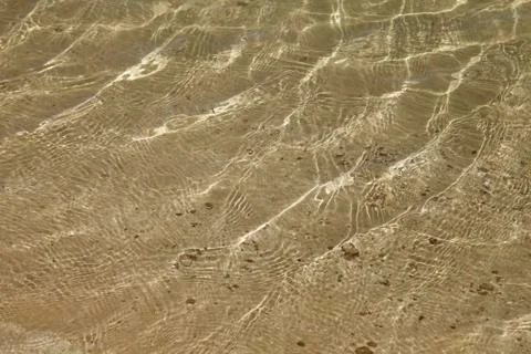 A background of sun and shadows on sandy ocean floor Stock Photos