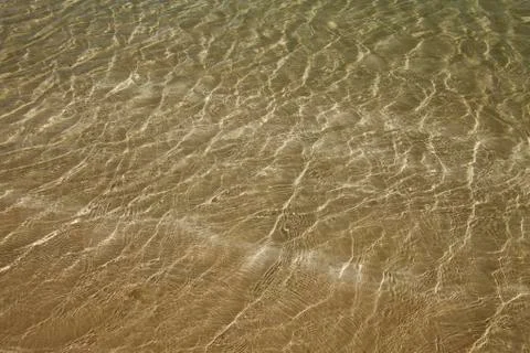 A background of sun and shadows on sandy ocean floor Stock Photos