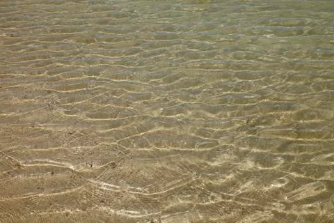A background of sun and shadows on sandy ocean floor Stock Photos