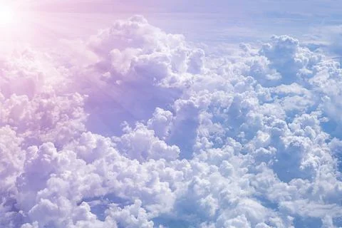 Background with sun rays over clouds. Aerial view from airplane. Stock Photos