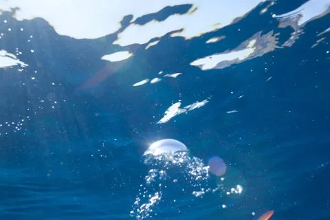 Background of sunlight bubbles in deep water Stock Photos