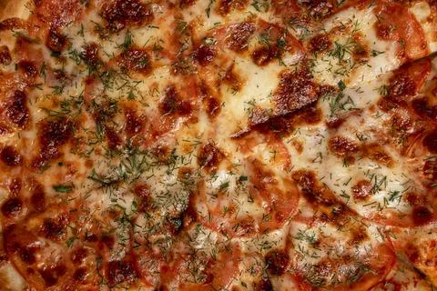 The background of the surface of a delicious pizza with cheese and dill Foto stock