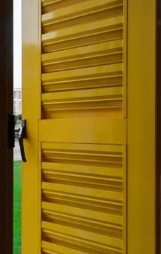 Background surface of open metal and yellow window shutter Stock Photos