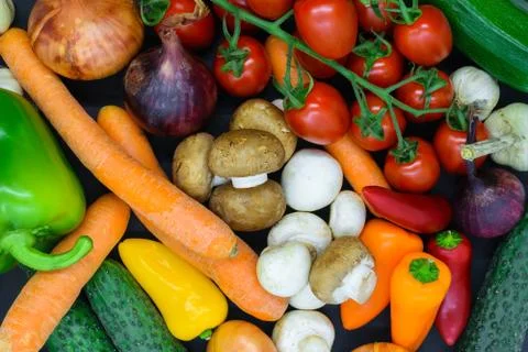Background surface of various vegetables placed on black background Stock Photos