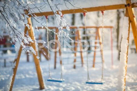 Background with swing in the park. winter Stock Photos