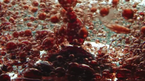 Background of swirling pink translucent particles sinking to the bottom Stock Footage 132177683