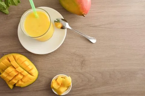 Background with table with mango juice and fruit top view Stock Photos