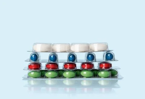 Background of tablets or pills on blue table. Medicine and pharmacy Stock Photos