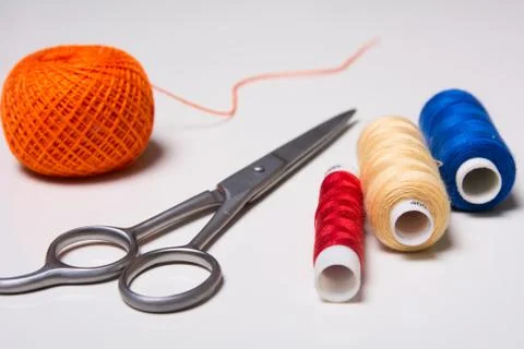 Background for tailor multicolored threads and scissors Stock Photos