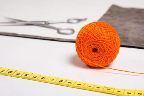 Background for tailor orange thread and sewing tools Stock Photos