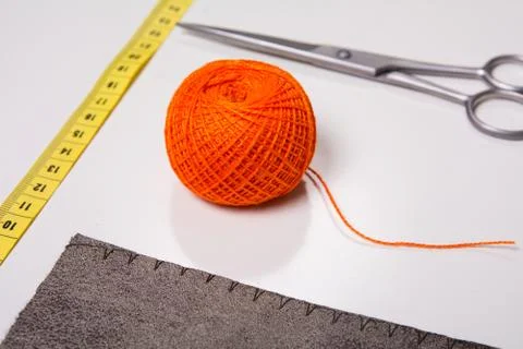 Background for tailor orange thread and sewing tools Stock Photos