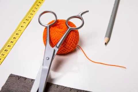 Background for tailor orange thread and sewing tools Stock-Fotos