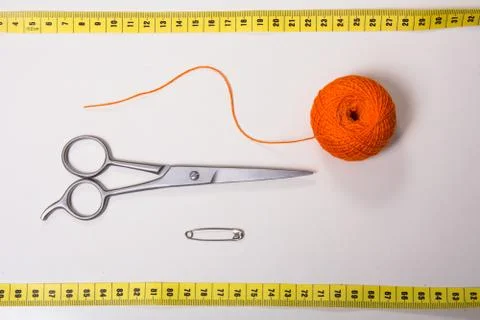 Background for tailor orange thread, measuring tape and scissors Stock Photos