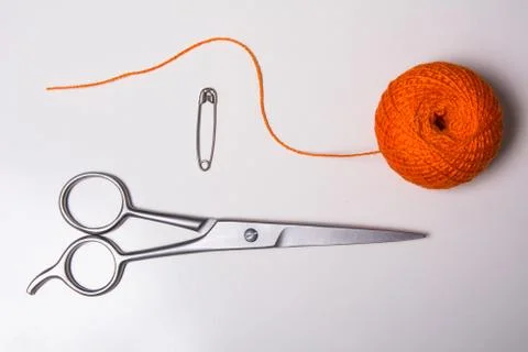 Background for tailor orange thread, pin and scissors Stock Photos