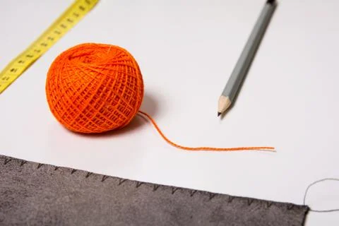 Background for tailor orange thread ribbon and pencil Stock Photos