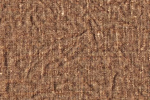Background of textile texture. Crumpled brown fabric Stock Photos