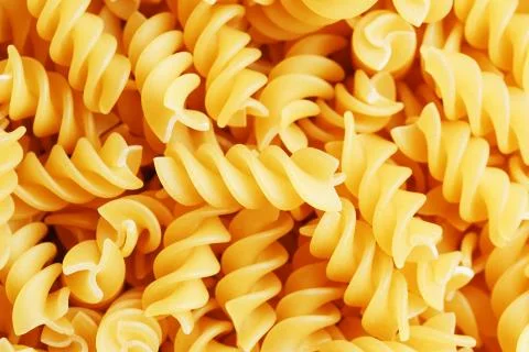 Background texture and pattern of boiled egg noodles in a spiral or pasta spa Stock Photos